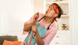 Funny guy dancing with broom